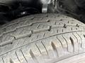 Close-up of a worn tire from a 2009 Toyota Hiace showing tread patterns and wear indicating usage and age