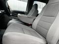Interior view of a 2007 Ford F-550 highlighting gray fabric seats with a central armrest and seatbelt in the passenger side