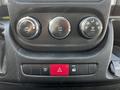 Three circular climate control dials with symbols for air circulation and air conditioning and a rectangular red button for hazard lights and another button labeled ESC OFF