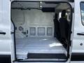 A 2018 Ford Transit van with an empty interior featuring a white floor and two front seats visible