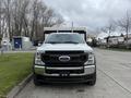 Front view of a 2021 Ford F600 truck with a white exterior and prominent grille displaying the Ford logo