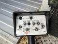 Control panel with buttons for throttle engine start emergency stop and boom operations on a 2008 Ford Econoline