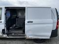 A 2018 Mercedes-Benz Metris van with an open sliding side door revealing an empty interior and a driver's seat visible