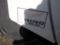 A close-up view of a 2015 Hino 195 truck showcasing a logo with the words Vancouver Hino Truck Sales