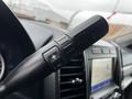 Close-up of the gear shift lever in a 2020 Ford F-350 SD featuring buttons for adjusting gears up and down