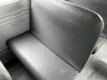 A worn gray vinyl seat from a 2015 Spartan School Bus showing signs of use and a simple design