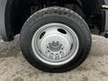 A silver wheel with a black tire mounted on a 2008 Ford F-450 SD