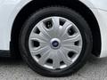 A close-up view of a silver alloy wheel with a Ford logo at the center and a black tire with tread patterns visible
