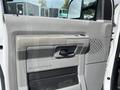 Interior door panel of a 2009 Ford Econoline featuring a textured surface and a mechanism for opening and closing the door