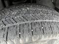 Close-up of a tire from a 2017 Ford F-250 showcasing a detailed tread pattern with visible debris embedded in the grooves