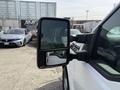 A 2011 Ford F-350 SD featuring a side mirror with dual reflections showing the vehicle's side and a nearby car in the background