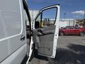 A 2016 Mercedes-Benz Sprinter with an open driver-side door displaying a gray interior and handle