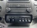 Dashboard controls of a 2016 Ford F-550 featuring knobs for air conditioning and four auxiliary switches