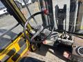 Interior view of a 1993 Hyster H80XL forklift showing the steering wheel, control levers, and dashboard with gauges and a red pressure gauge