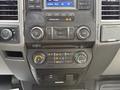 The interior dashboard controls of a 2017 Ford F-350 SD featuring audio and climate control buttons and knobs