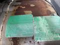 Close-up view of worn labels on a 2008 Mitsubishi Fuso FE180 engine providing technical specifications and information about engine limits and configurations