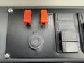 Control panel of a 2018 Grande West Vicinity featuring two red switches a circular key slot and several black buttons
