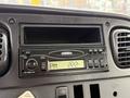 Dashboard of a 2005 Freightliner M2 106 featuring a radio display with digital clock, control buttons, and ventilation vents