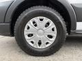 Close-up of a silver wheel with an angular design mounted on a rugged tire labeled Goodyear Wrangler