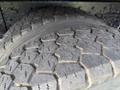 Close-up of a worn tire tread on a 2016 International 7600 showcasing deep grooves and contours designed for traction