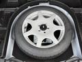 A spare tire mounted on a silver wheel designed for a 2020 Ford Escape with a tread pattern visible on the tire