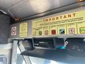 A 2012 Ford Econoline dashboard featuring a radio and speakers along with a notice board displaying important policies
