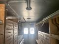 Interior view of a 2007 Morgan Olson Workhorse W42 featuring wooden drawers and storage compartments with pipes running along the ceiling and a set of double doors in the back