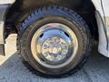 Close-up of a tire on a 2017 Chevrolet Express featuring a shiny chrome rim and rugged tread designed for off-road use