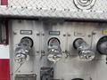 The image shows three chrome fire hose discharge valves labeled Discharge 1, Discharge 2, and Discharge 3 on a silver metal panel with a textured surface