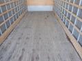 Interior of a 2014 International Durastar truck showing a wooden floor and metal side supports with no cargo present