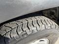 Close-up of a rugged tire from a 2015 Toyota Tacoma showing a detailed tread pattern designed for off-road traction