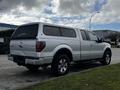 2014 Ford F-150 with a silver exterior and an extended cab parked on a street