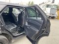 A 2021 Ford Explorer with an open back door showcasing the interior seating and door panel design