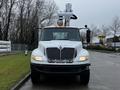 A white 2013 International DuraStar truck with an elevated work platform and orange safety lights on the cab