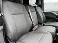 Two rows of gray fabric seats in a 2017 Ford F-150 interior with seat belts attached