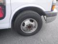 Close-up of the front wheel of a 2016 Chevrolet Express featuring a silver rim and a black tire with visible tread