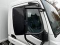 A white 2012 Mitsubishi Fuso FE truck with a large side mirror and angled cab view