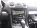 A 2016 Porsche Boxster dashboard displaying a navigation system screen with map instructions and radio settings