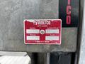 Close-up of a red and silver identification plate from a Waltco lift with model MDL-16 serial number 746646 and capacity of 1600 on a vehicle part