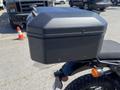 A black luggage box attached to the rear of a 2022 Royal Enfield Himalayan motorcycle