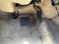 Foot pedals of a 2008 Newmar Canyon Star 36 Foot Class A Motorhome showing an accelerator pedal and a brake pedal on a carpeted floor