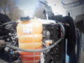 A 2016 International WorkStar 7500 engine compartment featuring a visible coolant reservoir with a Shell label and connected hoses