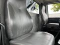 Two gray leather seats inside a 2017 International WorkStar 7600 truck cab with a simple design and ergonomic shape
