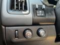 Close-up of the control panel in a 2021 Chevrolet Colorado featuring knobs for vehicle headlights and a switch for the interior light adjustment