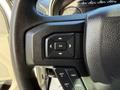 Steering wheel controls of a 2020 Ford F-550 featuring buttons for navigation settings and cruise control functions