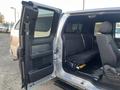 A 2014 Ford F-150 with an open rear door revealing a spacious back seat and black upholstery