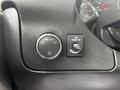 The control panel of a 2019 Chevrolet Express featuring a knob for automatic headlights and a switch to turn the dome light off