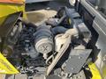 2010 Kubota F3990 engine with various components including hoses and a black cover with a warning label