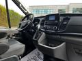 Interior view of a 2022 Ford Transit showing the dashboard gear shifter and touchscreen display