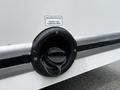 A fuel tank opening with a cap for a 2021 Ford E-450 labeled for unleaded fuel only